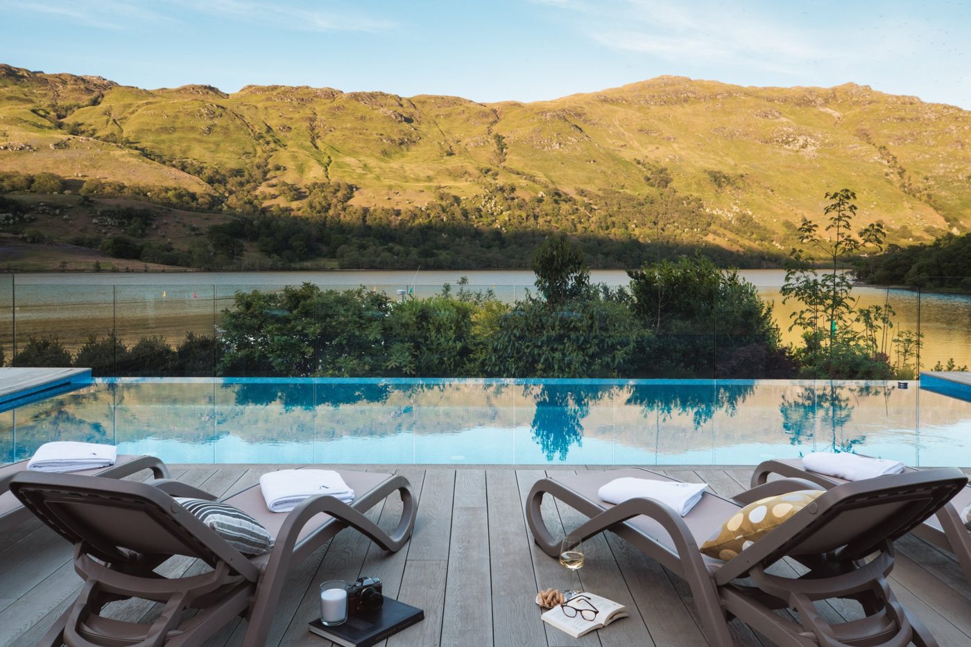Pool deck at Ardlui Retreat looking over Loch Lomond to the hills